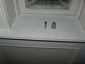 Flattened Tailors Thimble next to regular thimble